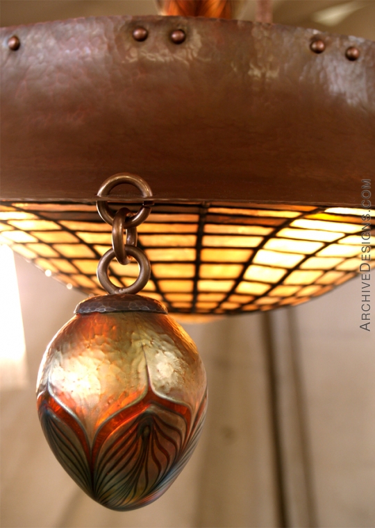 Custom designed and blown glass ball hanging from chandelier