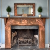 A near-reproduction of a copper fireplace surround originally designed by Walton. The Voysey wrought iron fire basket is also a near reproduction, as the structure has been modified for wood-burning in Sag Harbor instead of coal-burning in Glasgow or London. The clock and mirror are originals; probably Walton's.