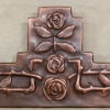 copper mirror frame with repoussé roses by Archive Designs.