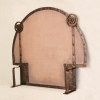 Hammered copper screen for arched fireplace, by Archive Designs.