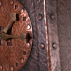 Hammered copper clock with amber mica and brass hands.