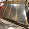 A burnished stainless & brass hood for a modern or traditional classic kitchen nearing completion in the shop. The burnished stainless has a more satin look than polished metal.