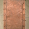 Kitchen hood in copper, with square solid copper rivets and lapped copper strapping